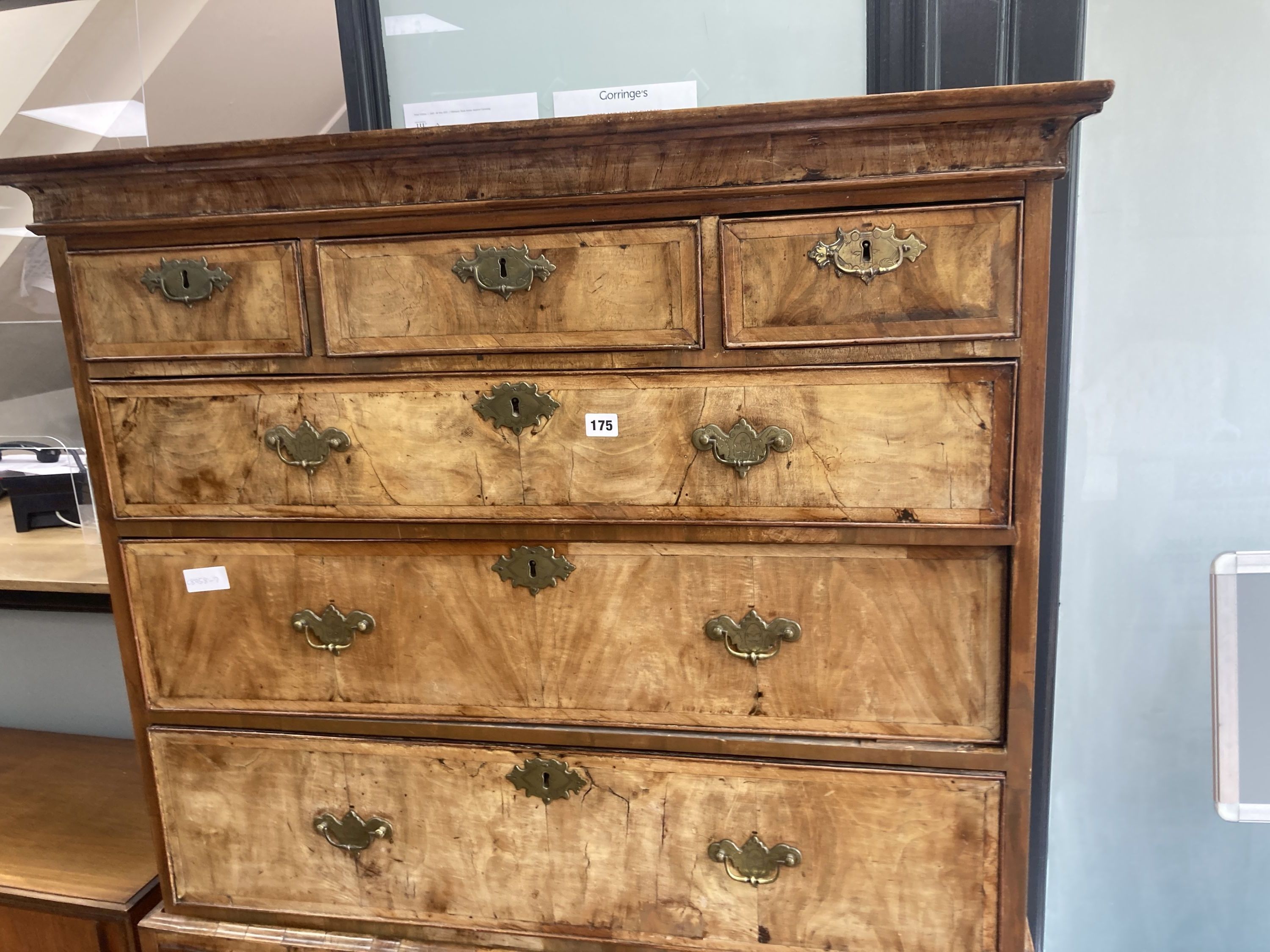 An early 18th century banded walnut tallboy, with oak sides, fitted three small and six long drawers with a brushing slide, width 105cm